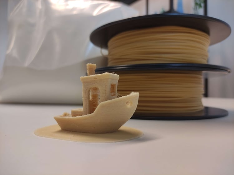 SLS Powder 3d printed boat with SLS filament behind it